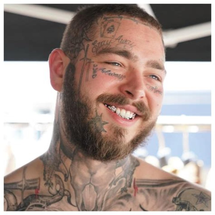 a person with a tattoo on their arm that has an image of the sun and