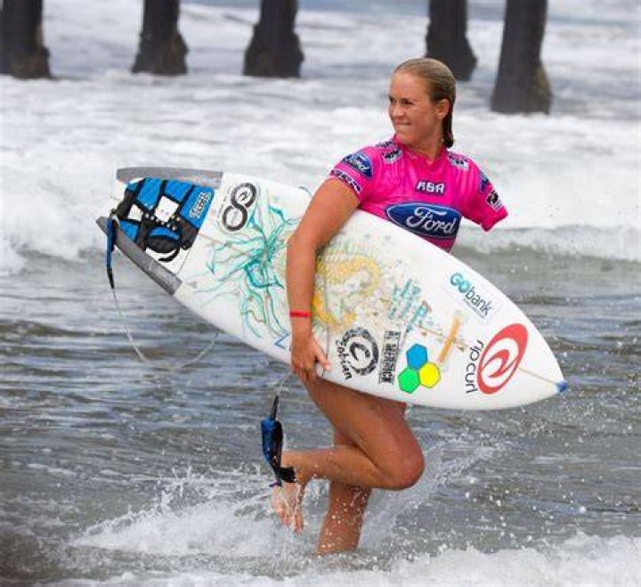 Bethany Hamilton beams as she's lifted into the air by new husband Adam
