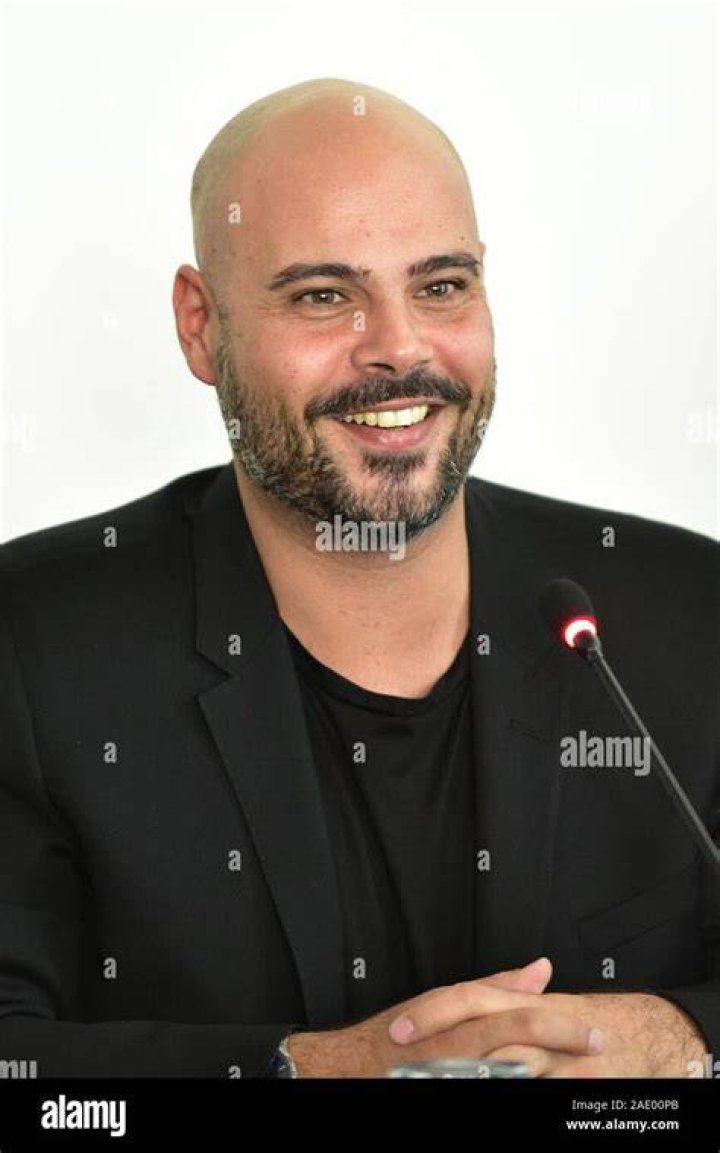 Italian actor Marco D'Amore with his fiancee Daniela attend the red
