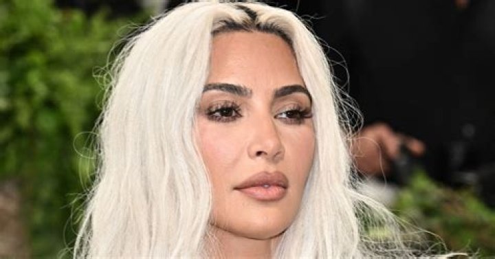 Kim Kardashian highlights her famous backside in a skintight dress as