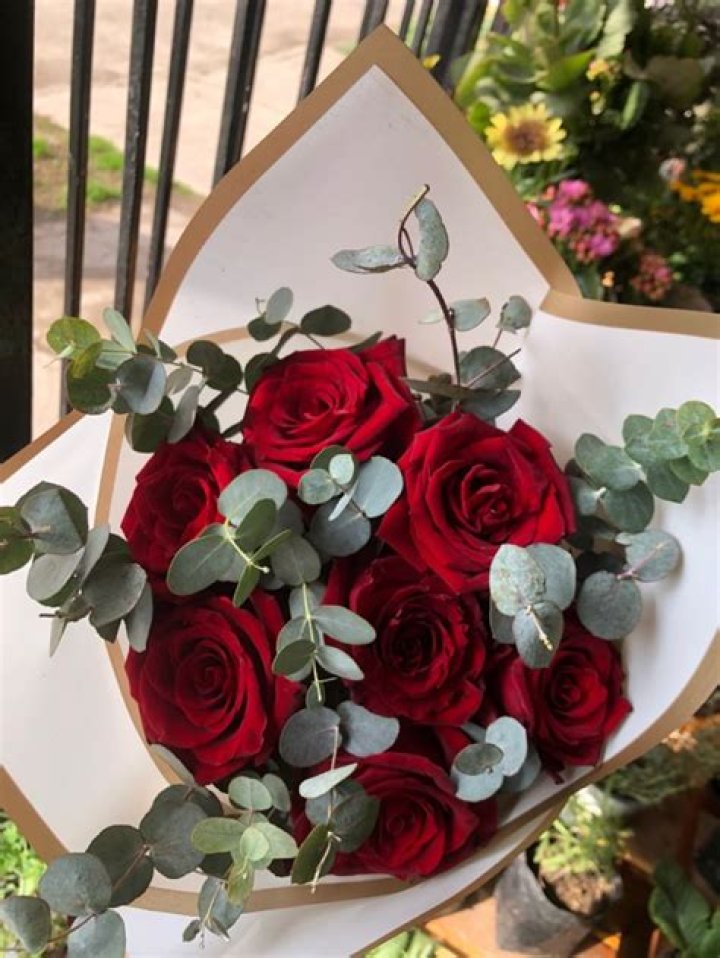 Red roses handteid with Eucalyptus Cinerea and salal, and finished