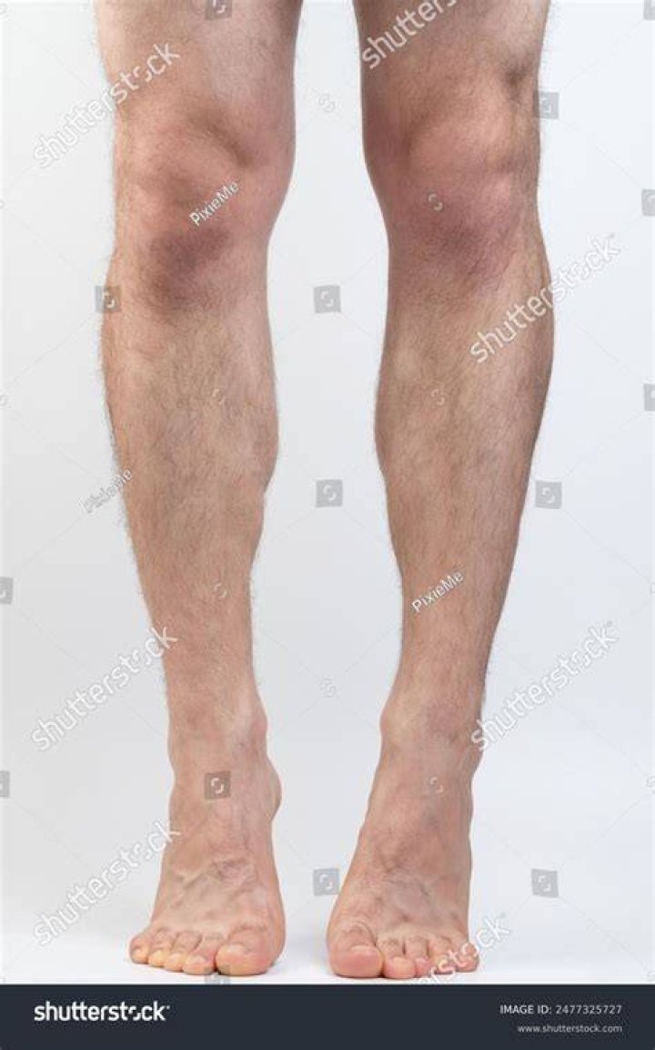 the legs of a person wearing socks with orange and brown designs on