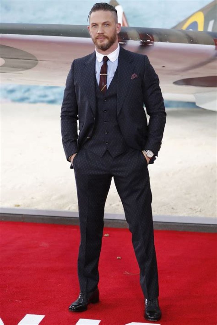 Tom Hardy in welltailored suit with Noomi Rapace at the Child 44