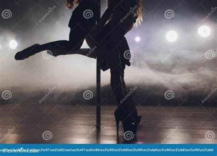 young striptease dancer moving in high heels shoes on stage in strip